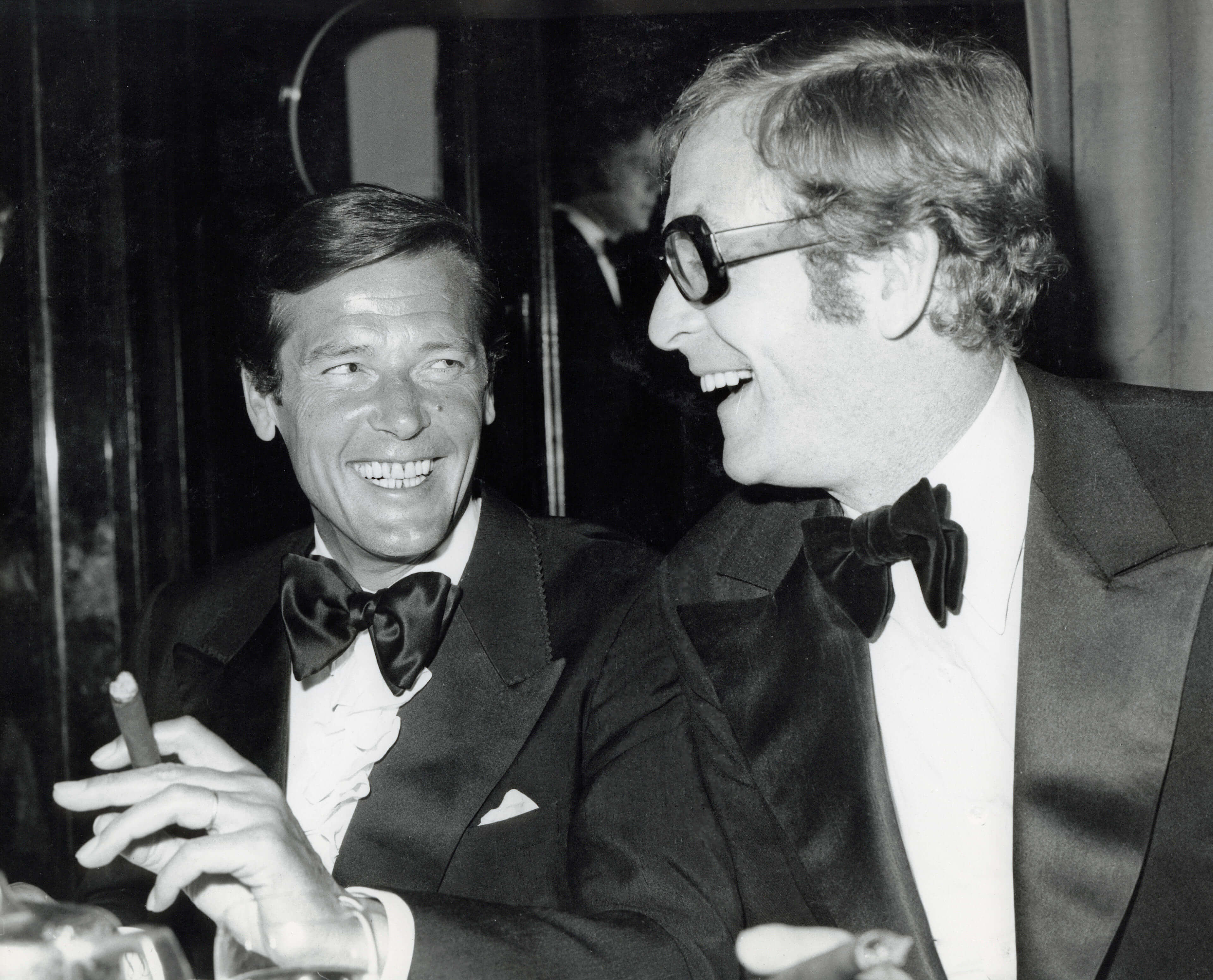 Roger with Michael Caine in 1973. PictureLux / The Hollywood Archive / Alamy Stock Photo.